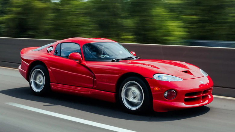 A red Dodge Viper driving on a freeway