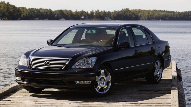 A black LS460 parked on a dock on the water