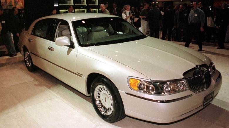 A vintage photo of a white Lincoln town car