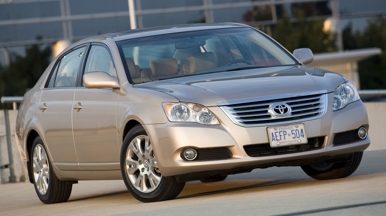 A gold Avalon parked at a jaunty angle