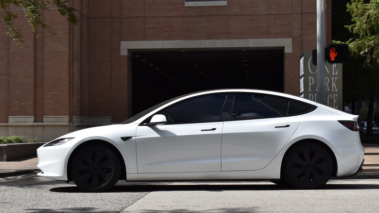 A photo of a white Tesla Model 3 EV.