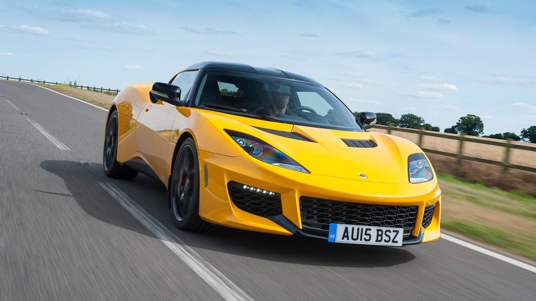 A photo of a yellow Lotus Evora sports car.