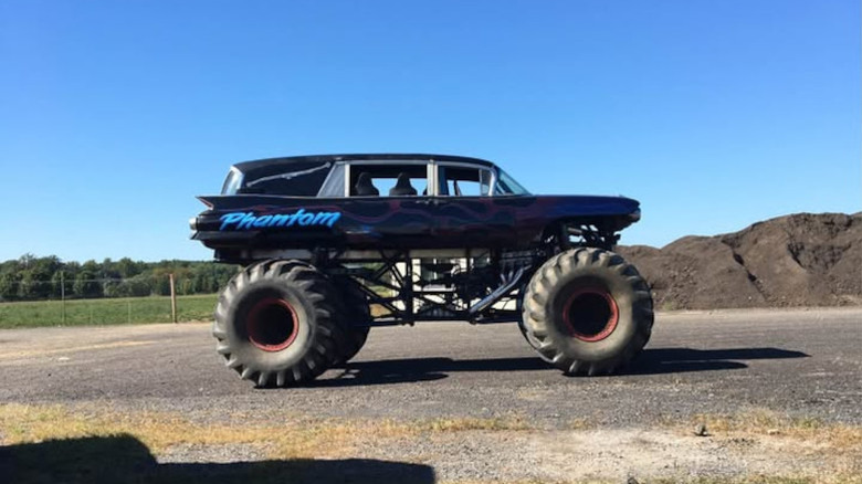 A Cadillac hearse body on a monster truck frame