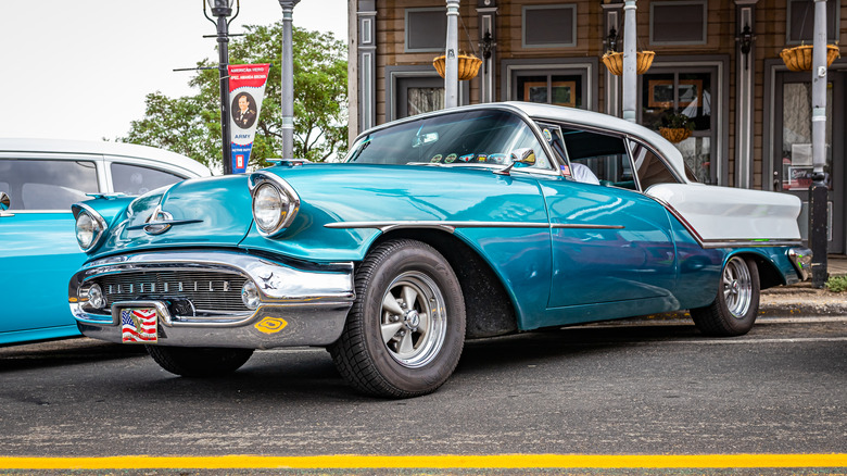 A 1957 Oldsmobile Golden Rocket 88 Hardtop Coupe in two-tone blue and white.