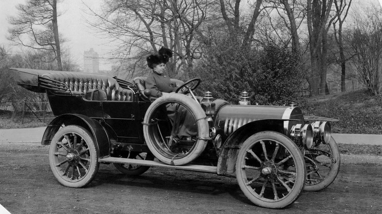 Racing driver Joan Cuneo posing with her 1908 Rainier racecar.