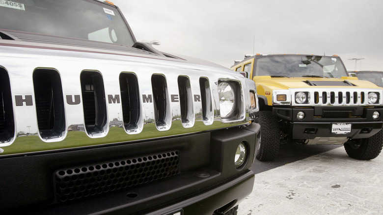 two hummer H2s parked in a parking lot