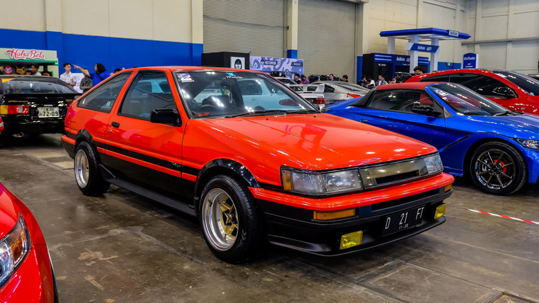 A red Toyota AE86 Levin hatchback