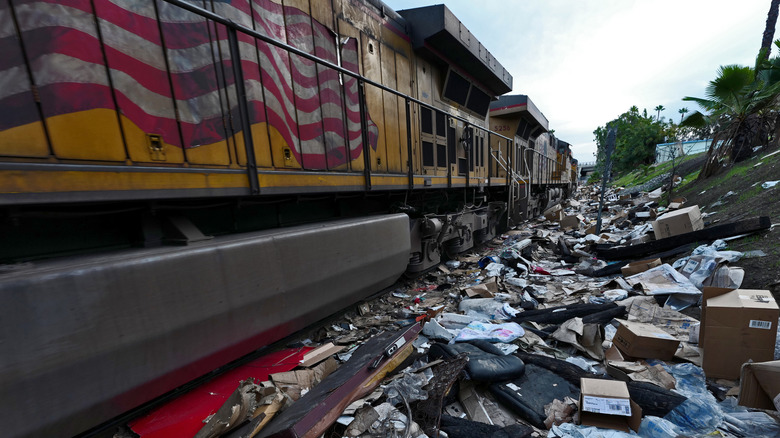 A photo of trash left by the side of train tracks.