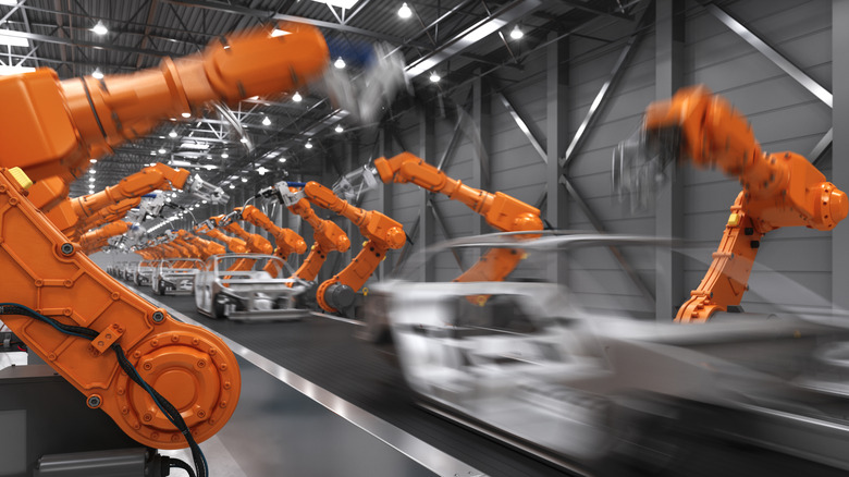 A photo of robots assembling cars at a factory.