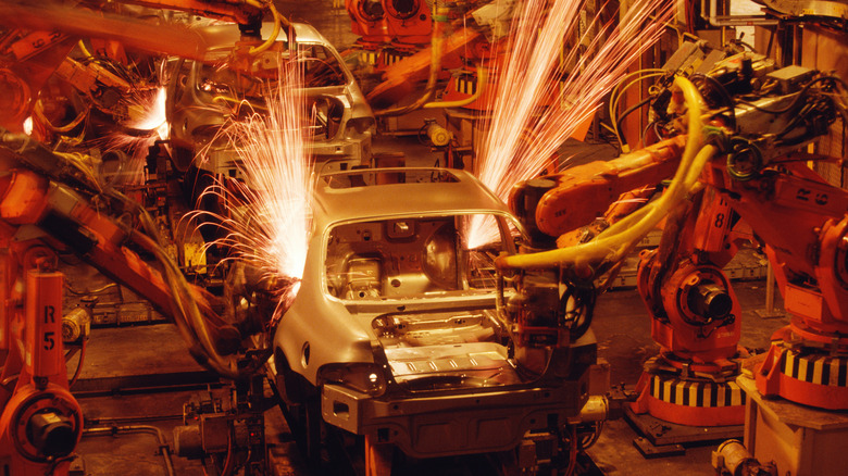 A photo of cars being built at a factory.