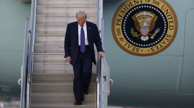 US President Donald Trump exits from Air Force One at Palm Beach International Airport on February 14, 2025 in West Palm Beach, Florida.