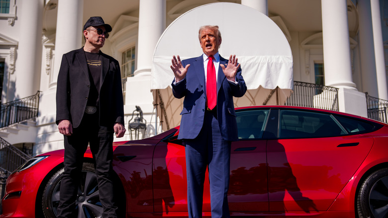 Donald Trump and Elon Musk stand in front of a Tesla Model S at the White House