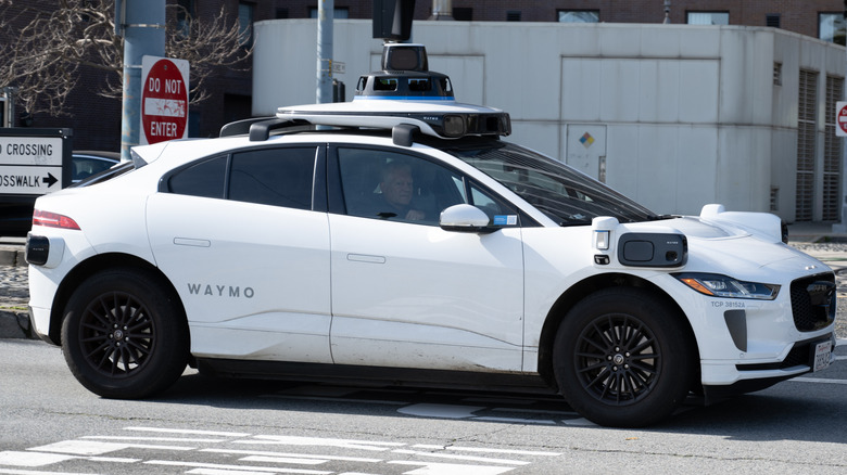 Waymo self-driving electric car navigating an intersection near the Embarcadero in San Francisco, California, February 21, 2025.