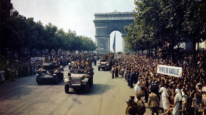 Crowds of French patriots line the Champs Elysees to view Free French tanks and half tracks of General Leclerc's 2nd Armored Division passes through the Arc du Triomphe, after Paris was liberated on August 26, 1944.