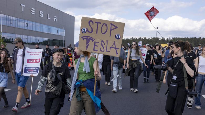 nvironmental activists protest near the Tesla Gigafactory electric car factory on May 11, 2024 close to Gruenheide, Germany.