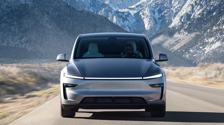 A render of a Tesla Model Y on a mountain road.