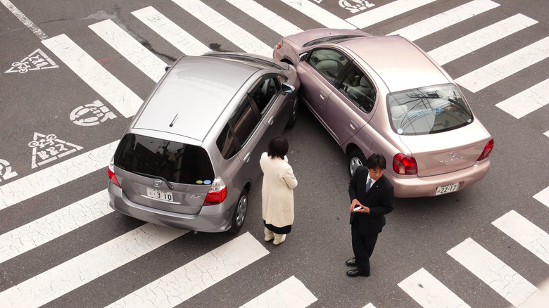 a silver Honda Fit hit a light pink Toyota Echo in Japan