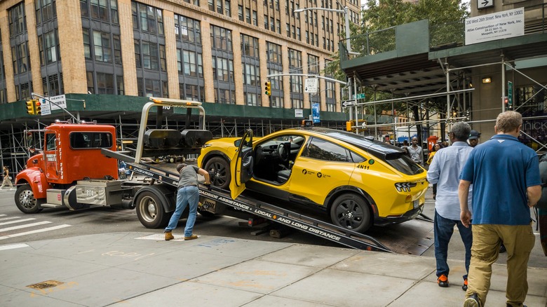 A Ford Mustang Mach-E taxi being towed away in New York City