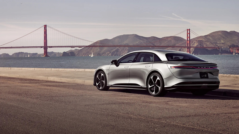 A gray Lucid Air Touring on a quay with the Golden Gate Bridge in the background.