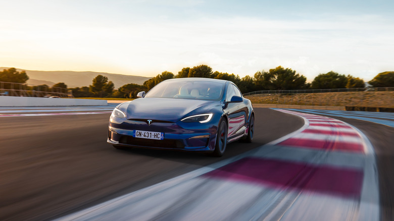 A blue Tesla Model S driving around Circuit Paul Ricard in France.