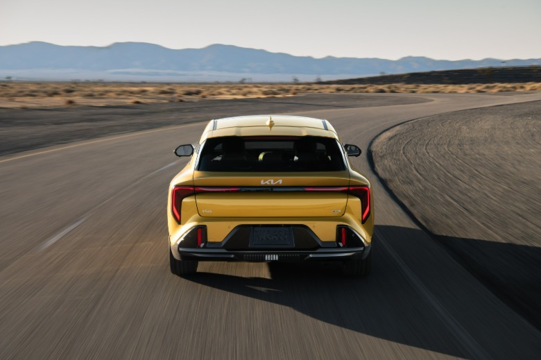 Rear view of a yellow Kia K4 hatchback