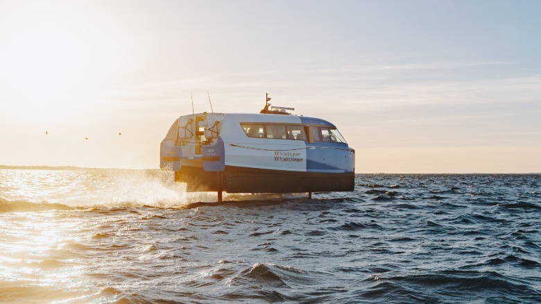 a P-12 on its foils in choppy waters at sunset