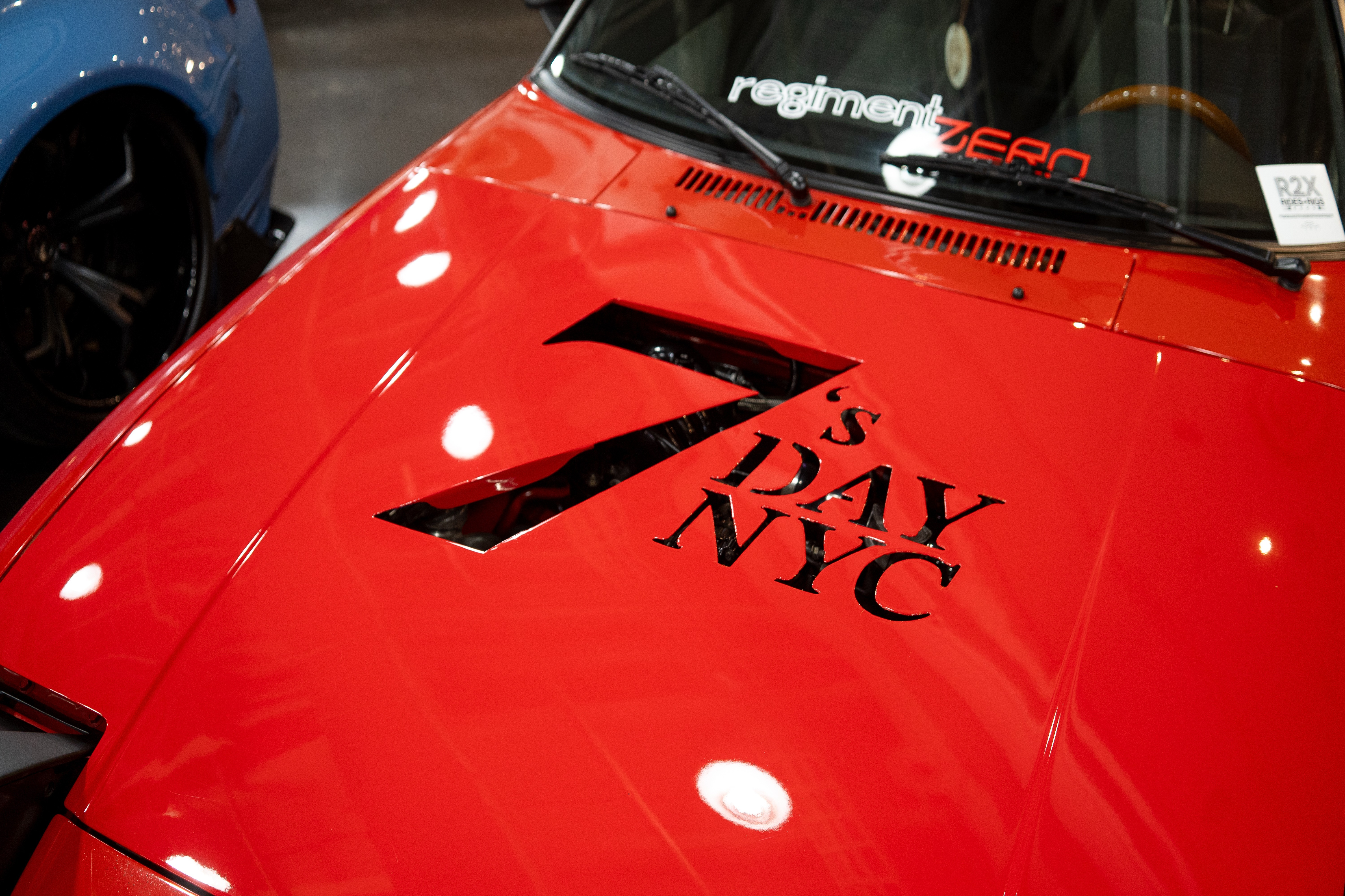 The hood of a red Mazda RX-7 FB
