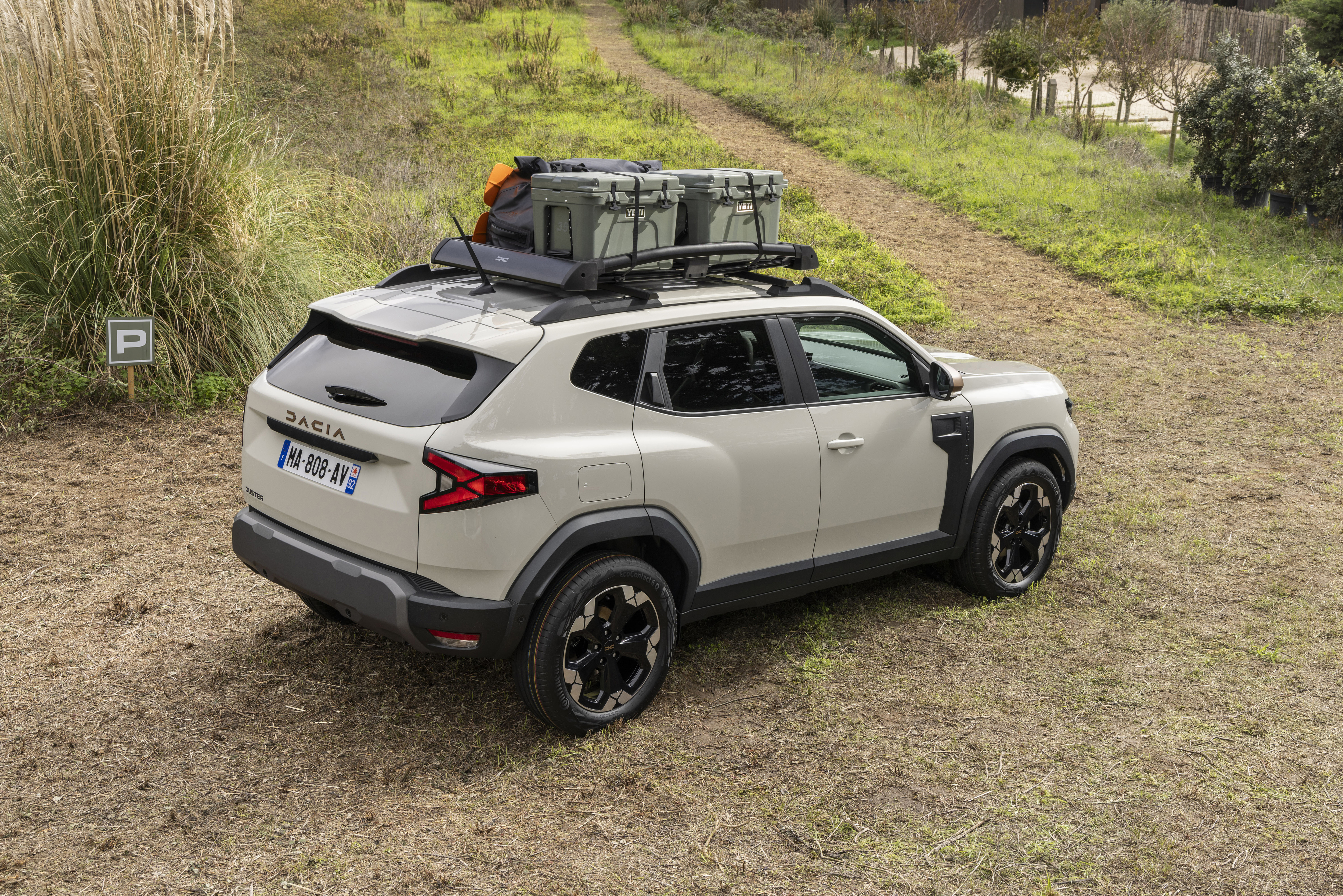 Rear 3/4 view of a Dacia Duster in a field