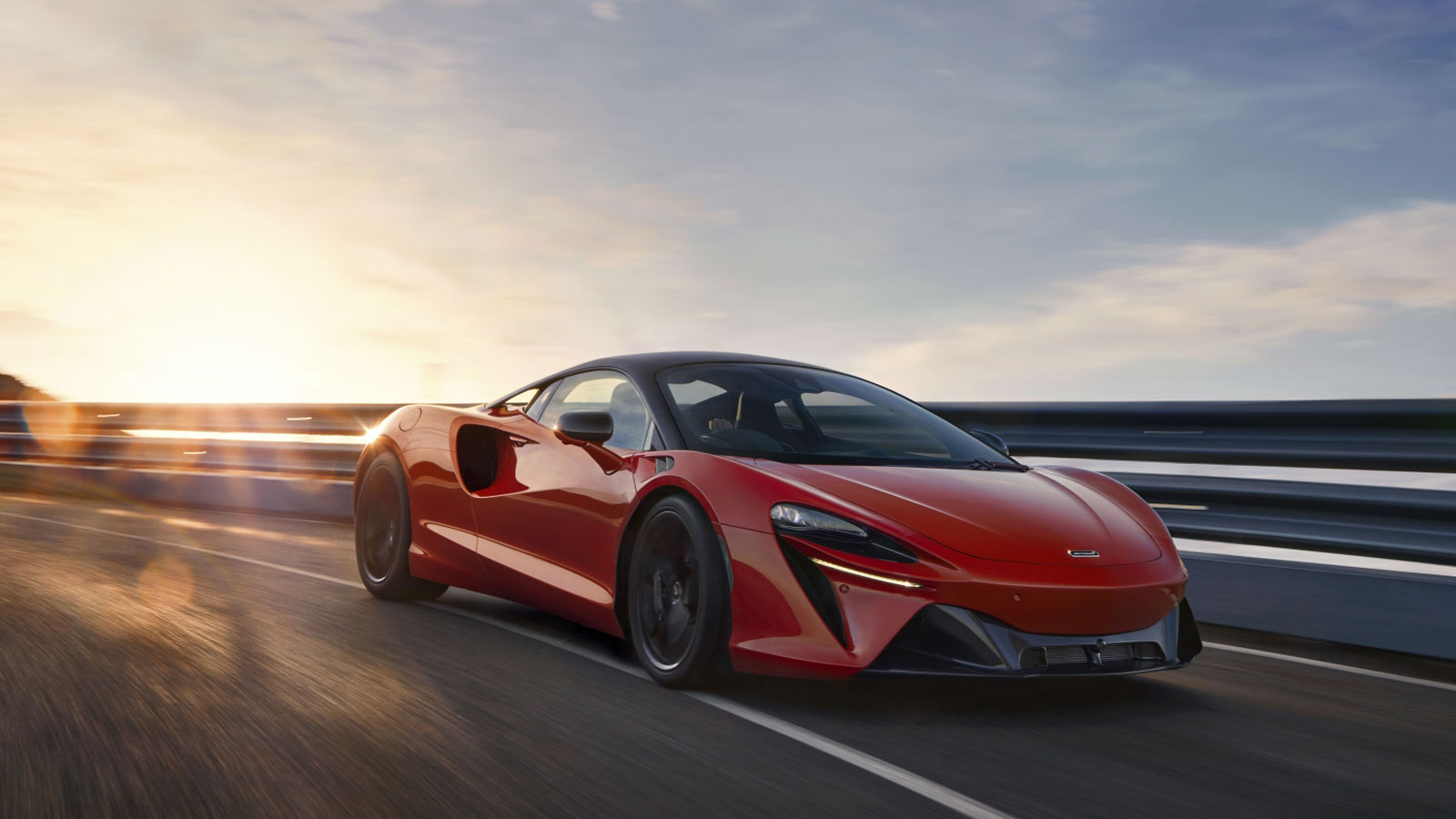 A photo of a red McLaren Artura supercar. 