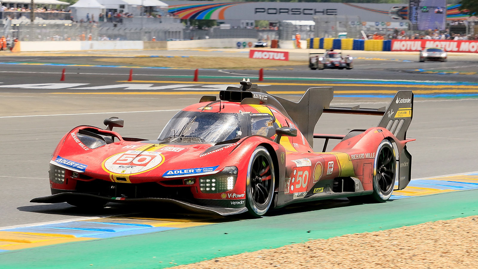 A photo of the Ferrari 499P racing at Le Mans. 