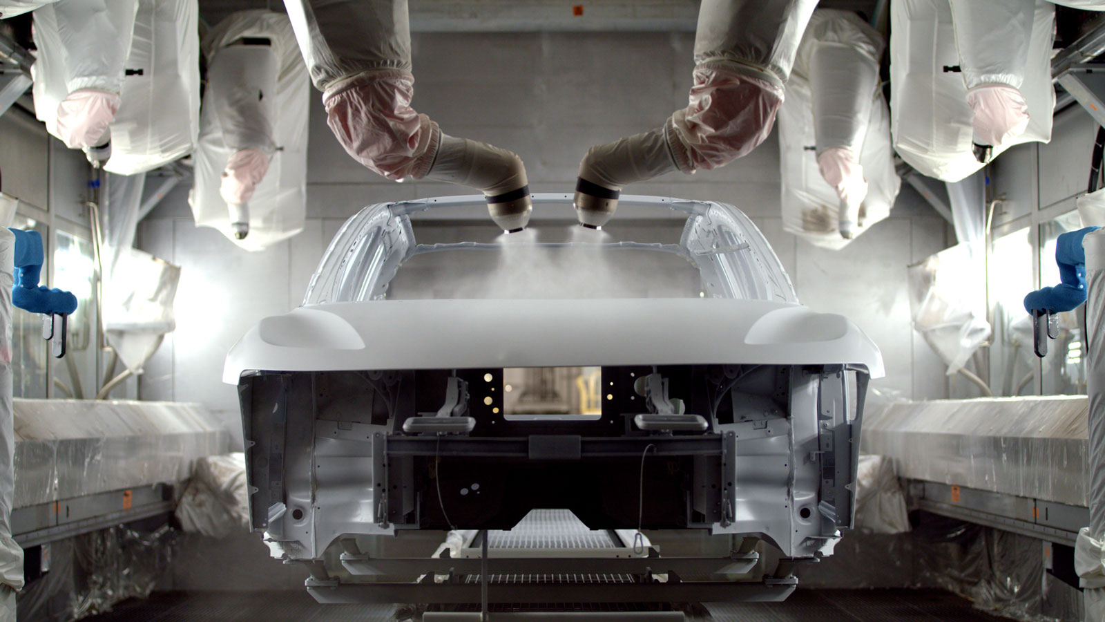 A photo of a Lucid Air sedan being painted by robots. 