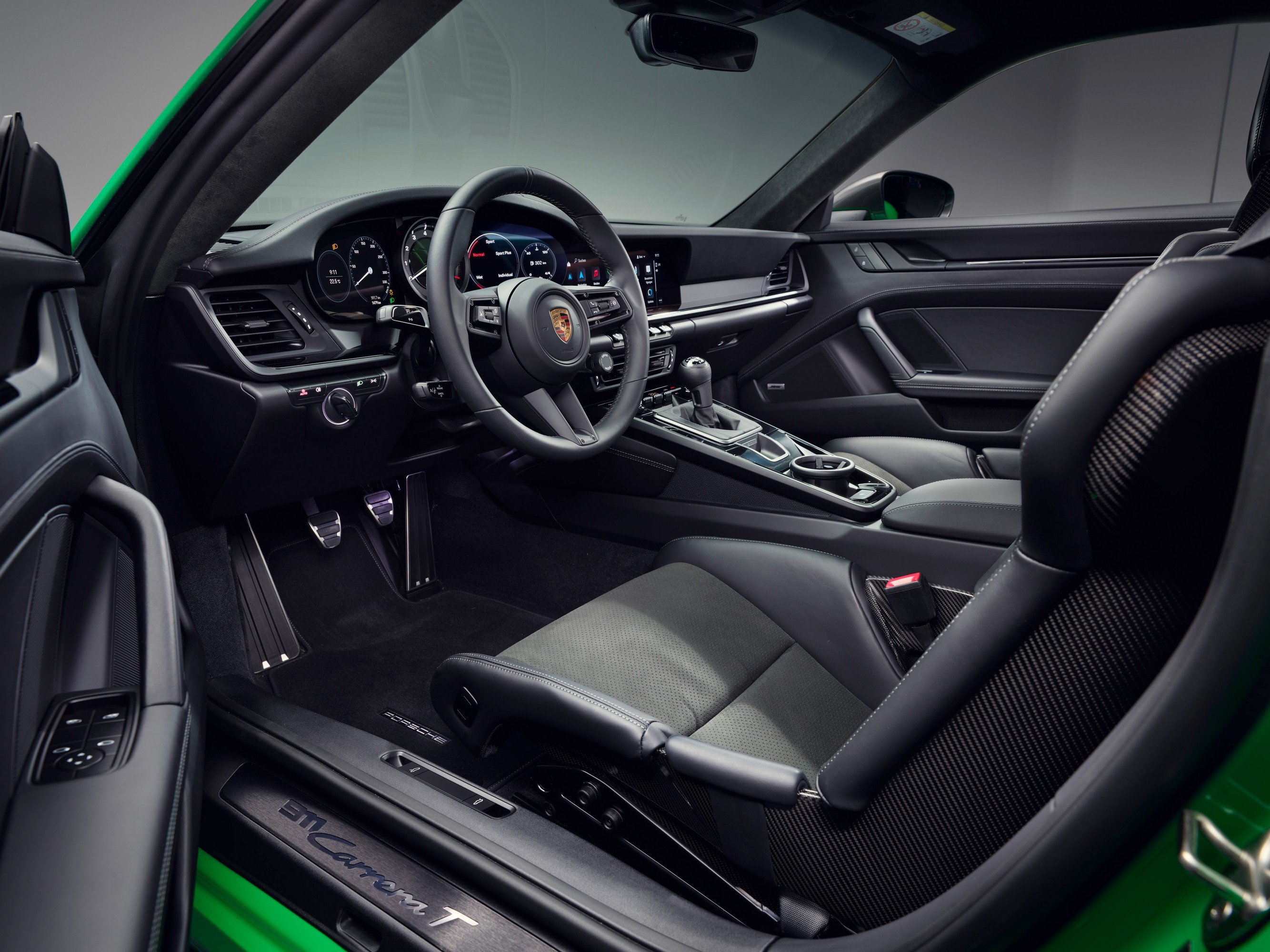 The interior of the Porsche 911 Carrera T with carbon fiber bucket seats.