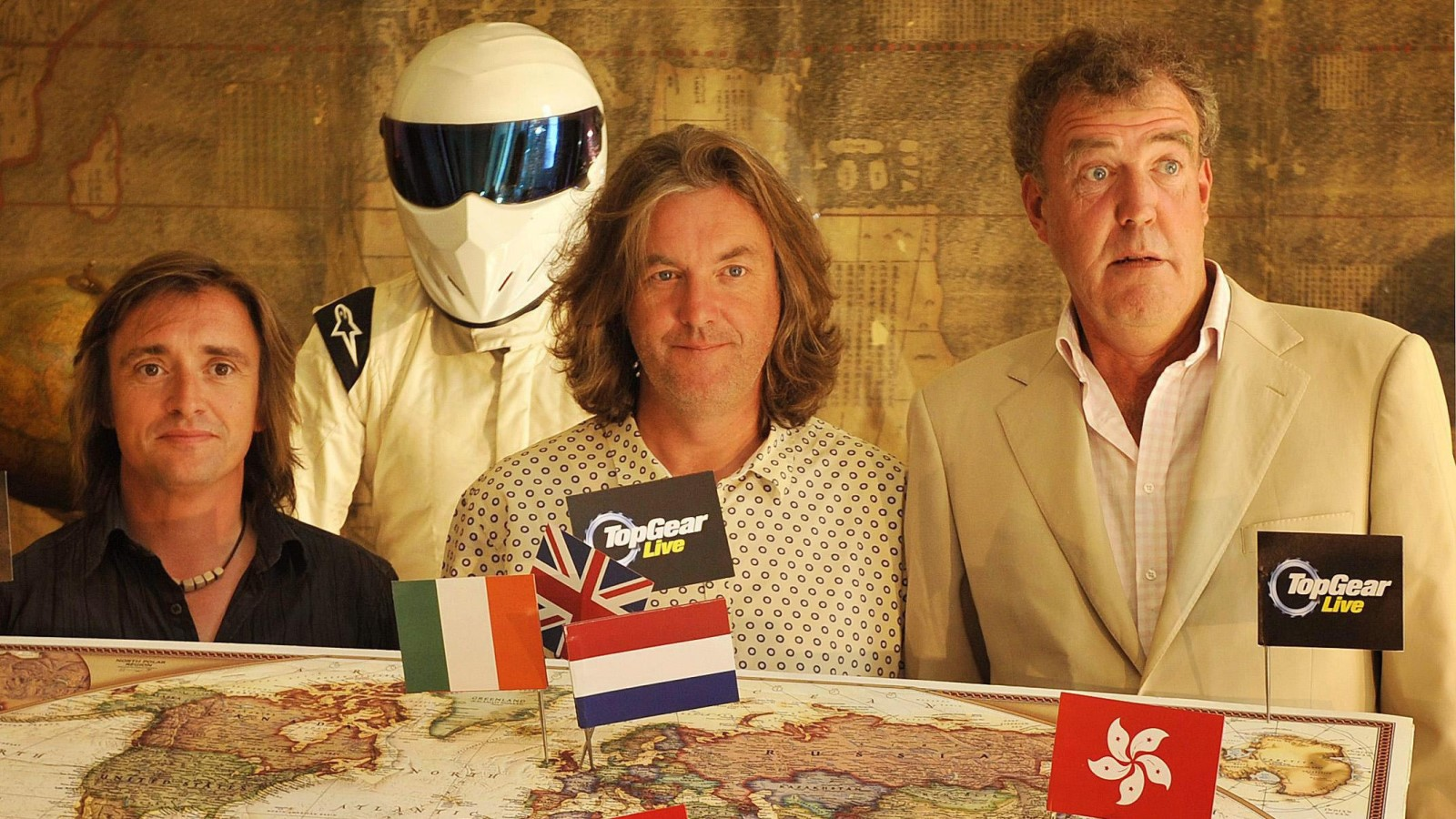 A photo of The Stig with James May, Richard Hammond and Jeremy Clarkson. 