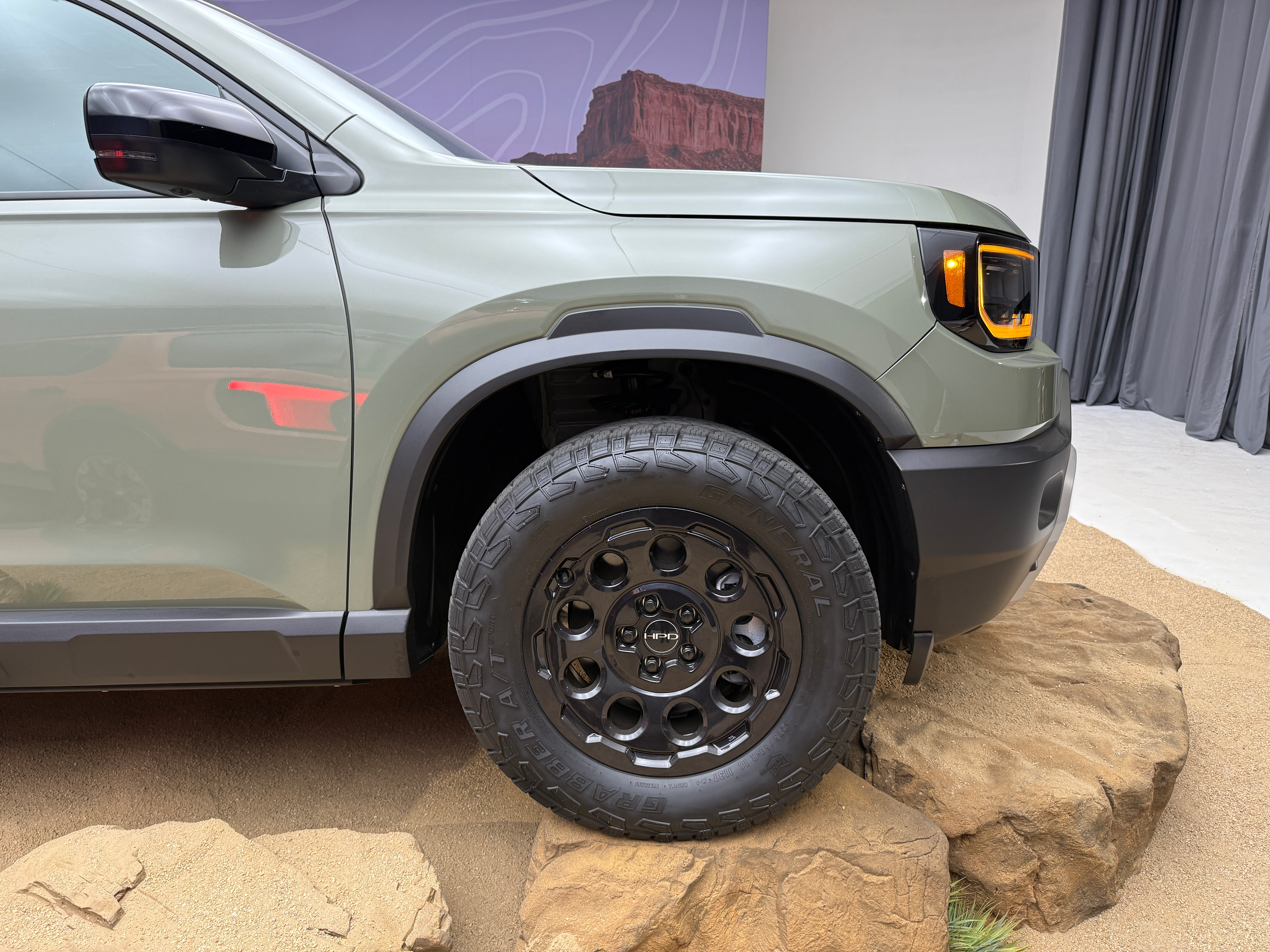 Front wheel of a green 2026 Honda Passport TrailSport