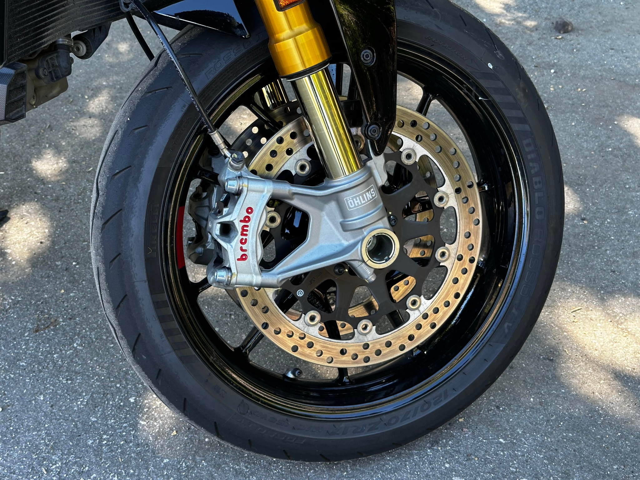 The front brakes, wheel and fork end of the 2023 Ducati Monster SP