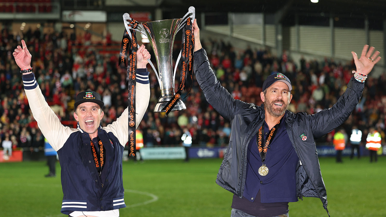 Rob McElhenney and Ryan Reynolds hold the Vanarama National League Trophy