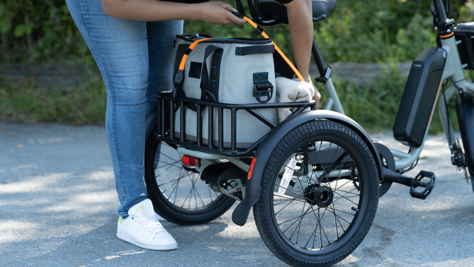 A photo of someone loading the cargo space on the RadTrike. 