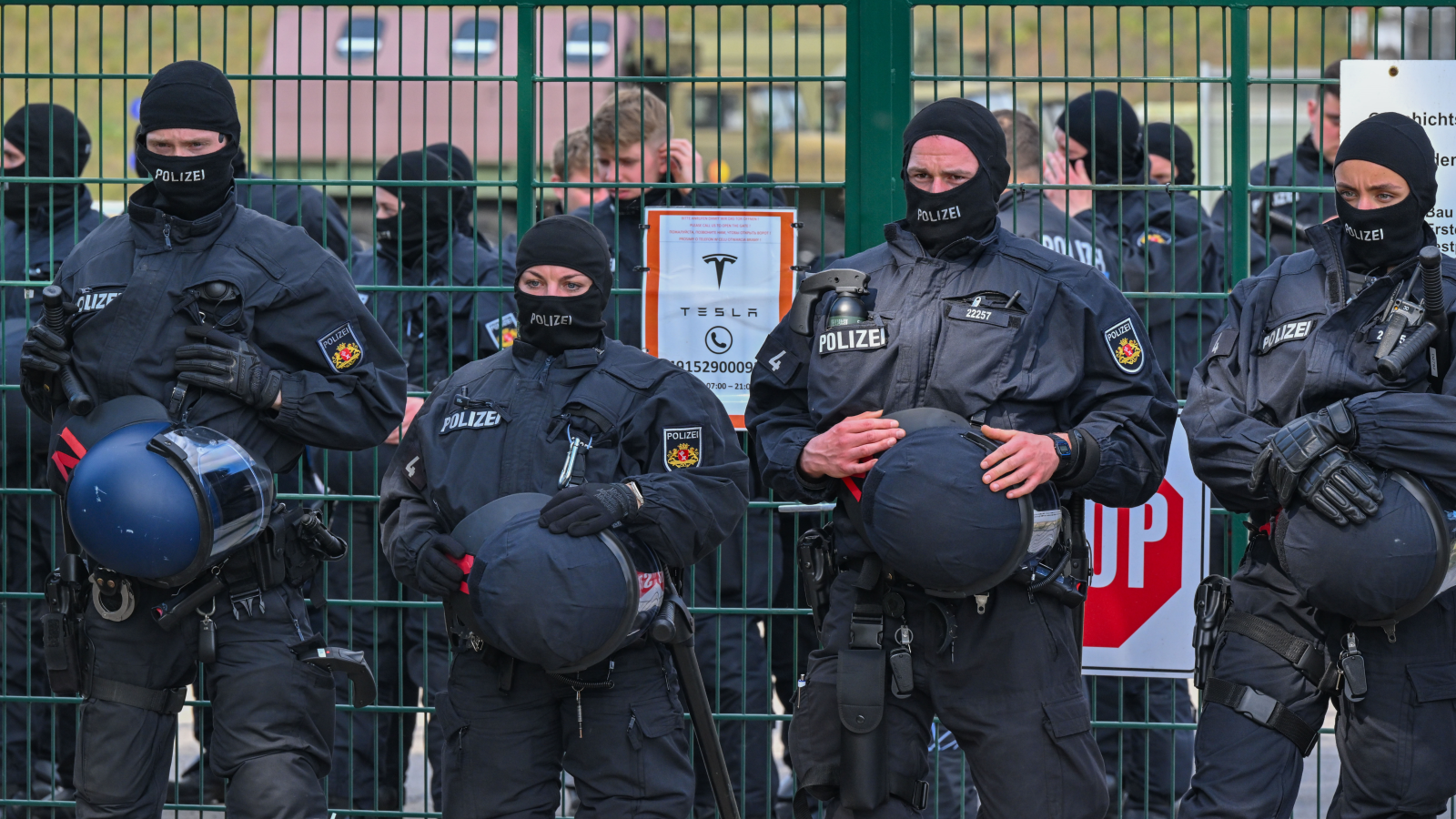 A photo of police officers guarding a Tesla site. 