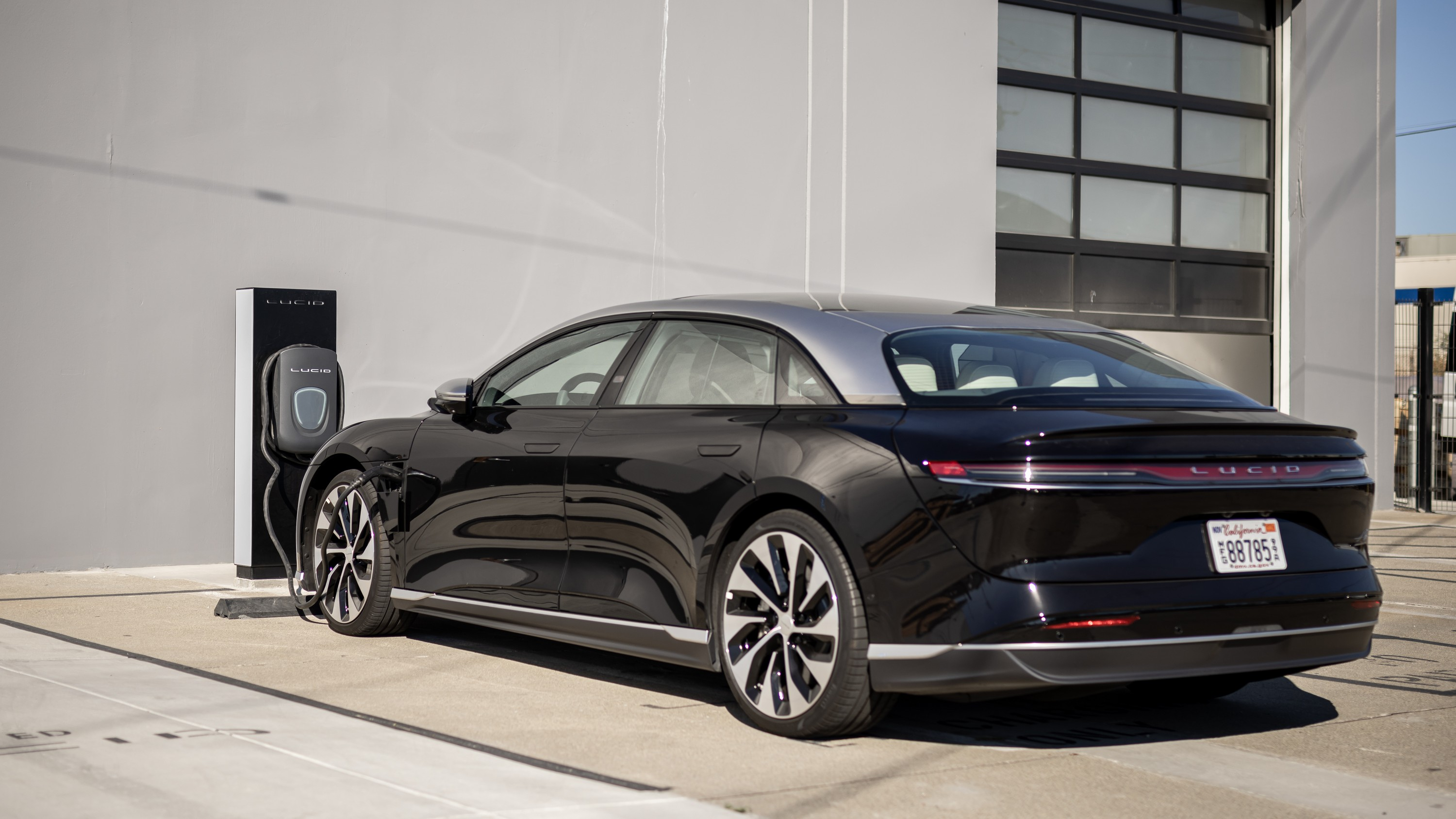 Lucid Air parks in front of a charger