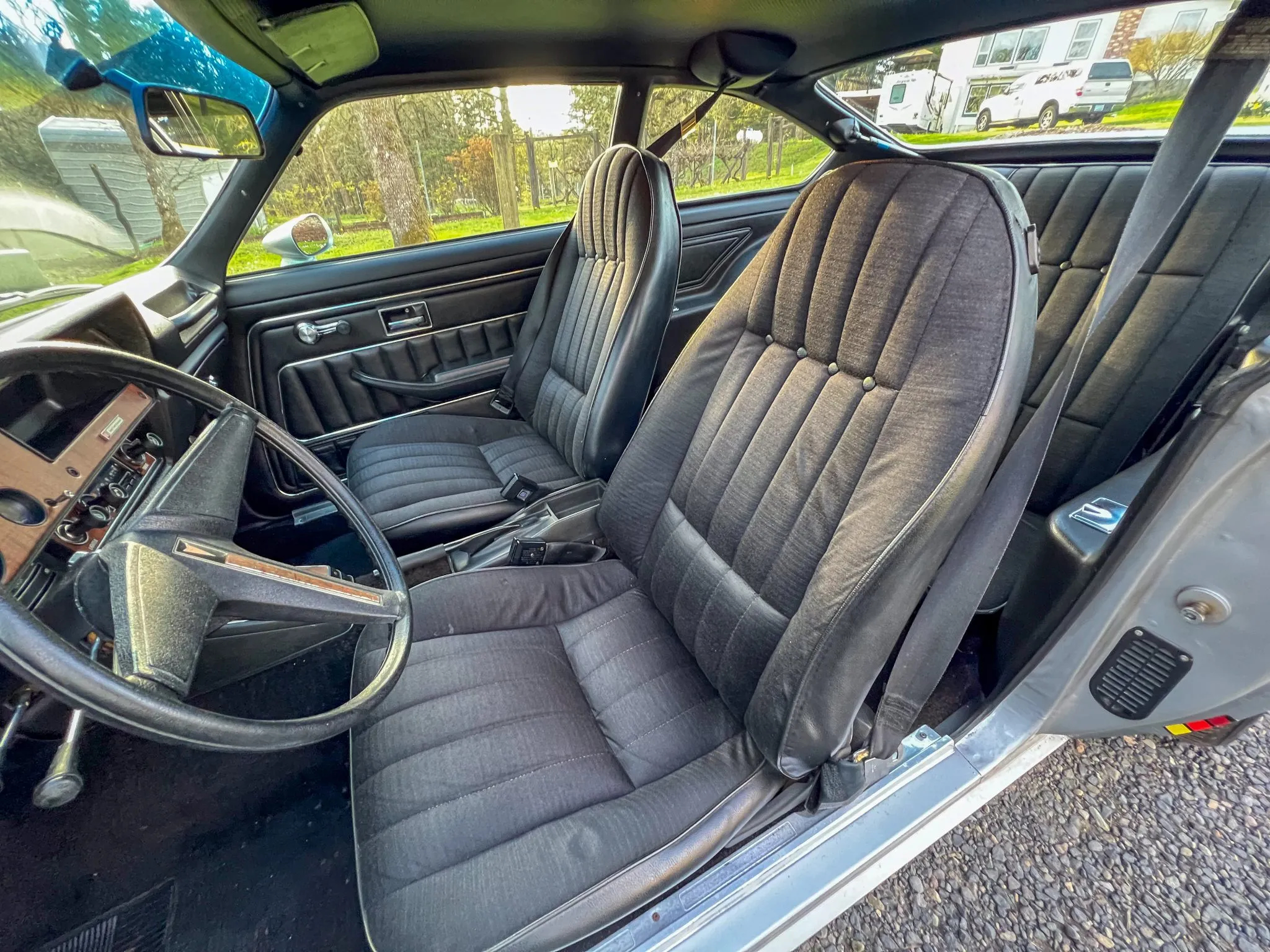 A photo of the interior and the pleated gray cloth seats