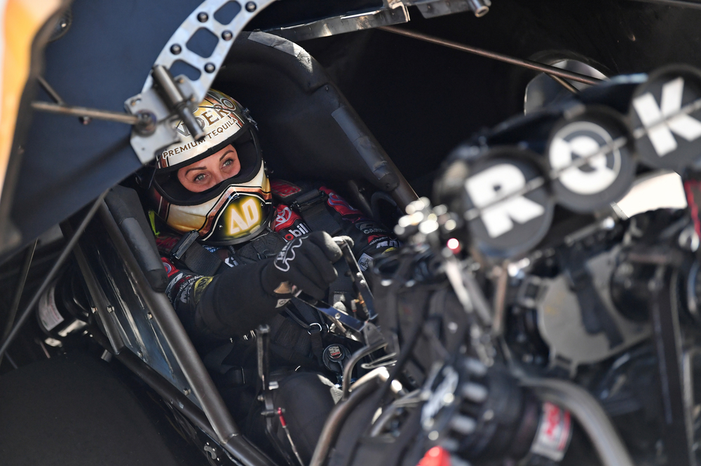 Alexis DeJoria suited up in the cockpit of her NHRA Funny Car race car