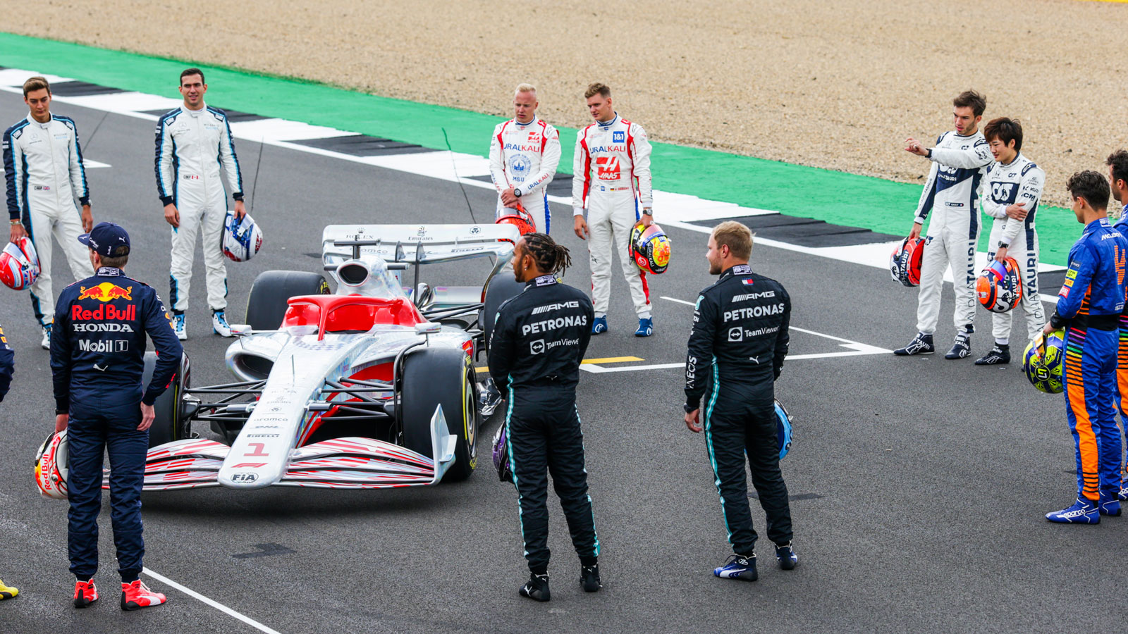 The 2021 F1 drivers gather round a model of the 2022 F1 car