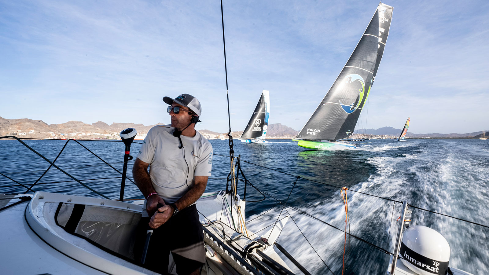 A photo of three boats following the 11th hour Racing ship. 