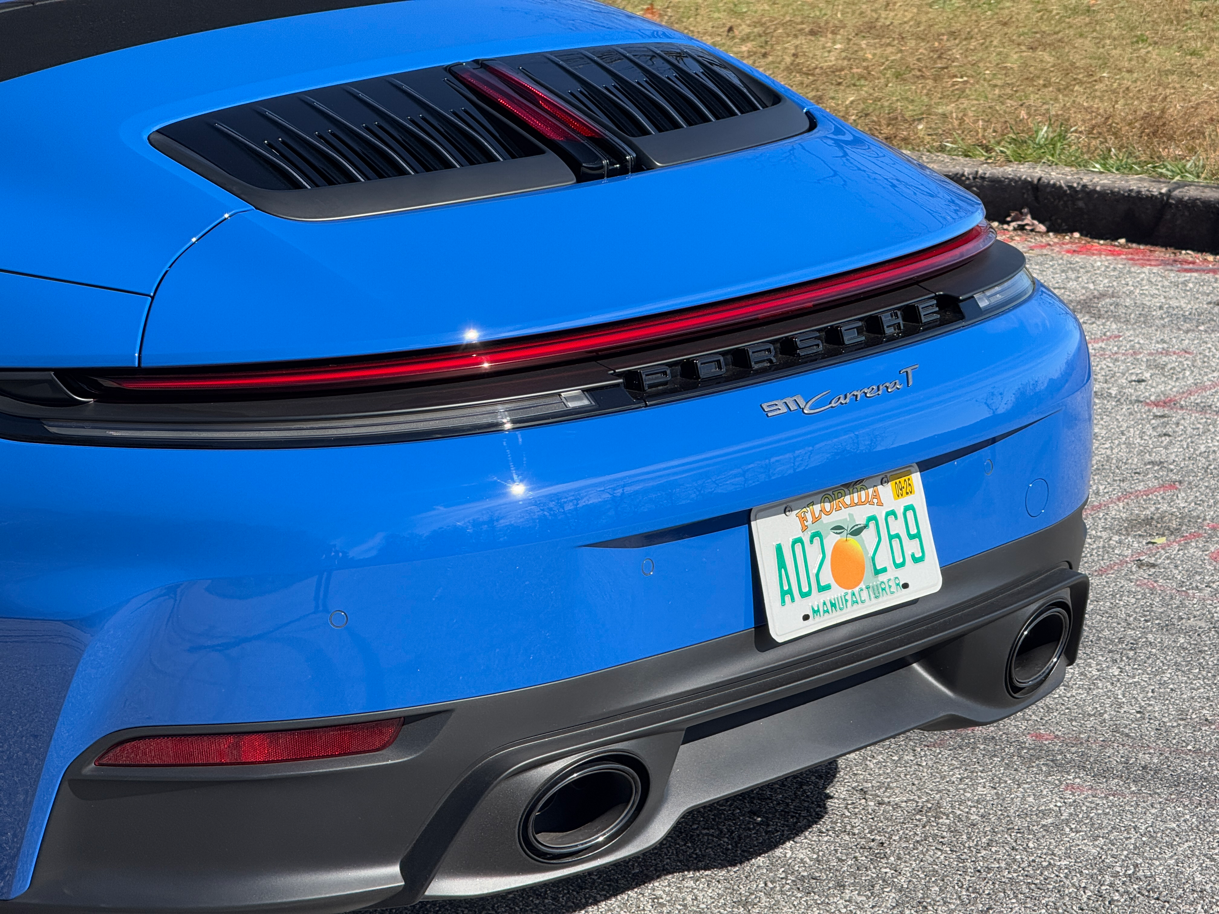 Rear end of a blue 2025 Porsche 911 Carrera T cabriolet