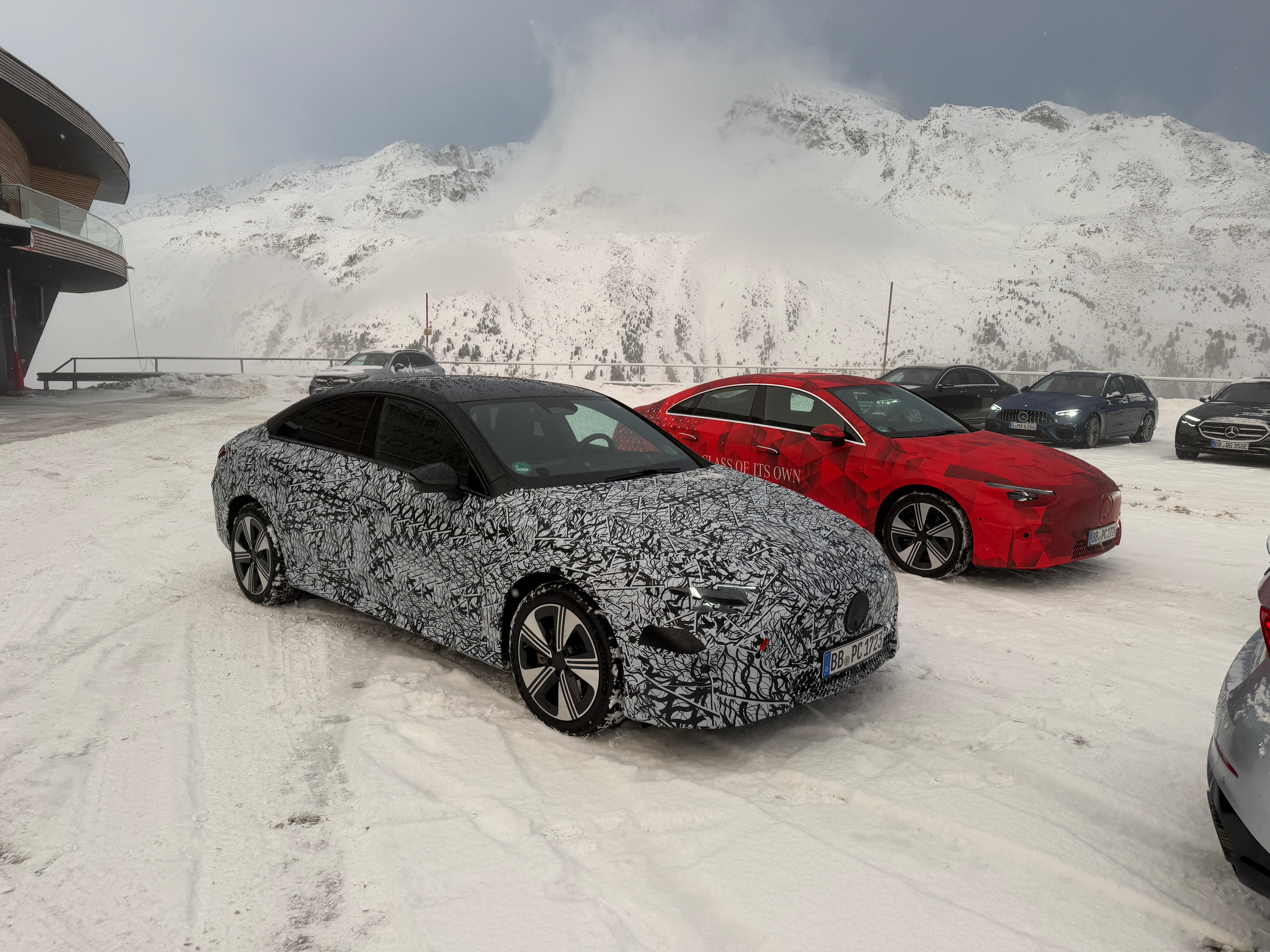 Front 3/4 view of two camouflaged Mercedes-Benz CLA EV prototypes