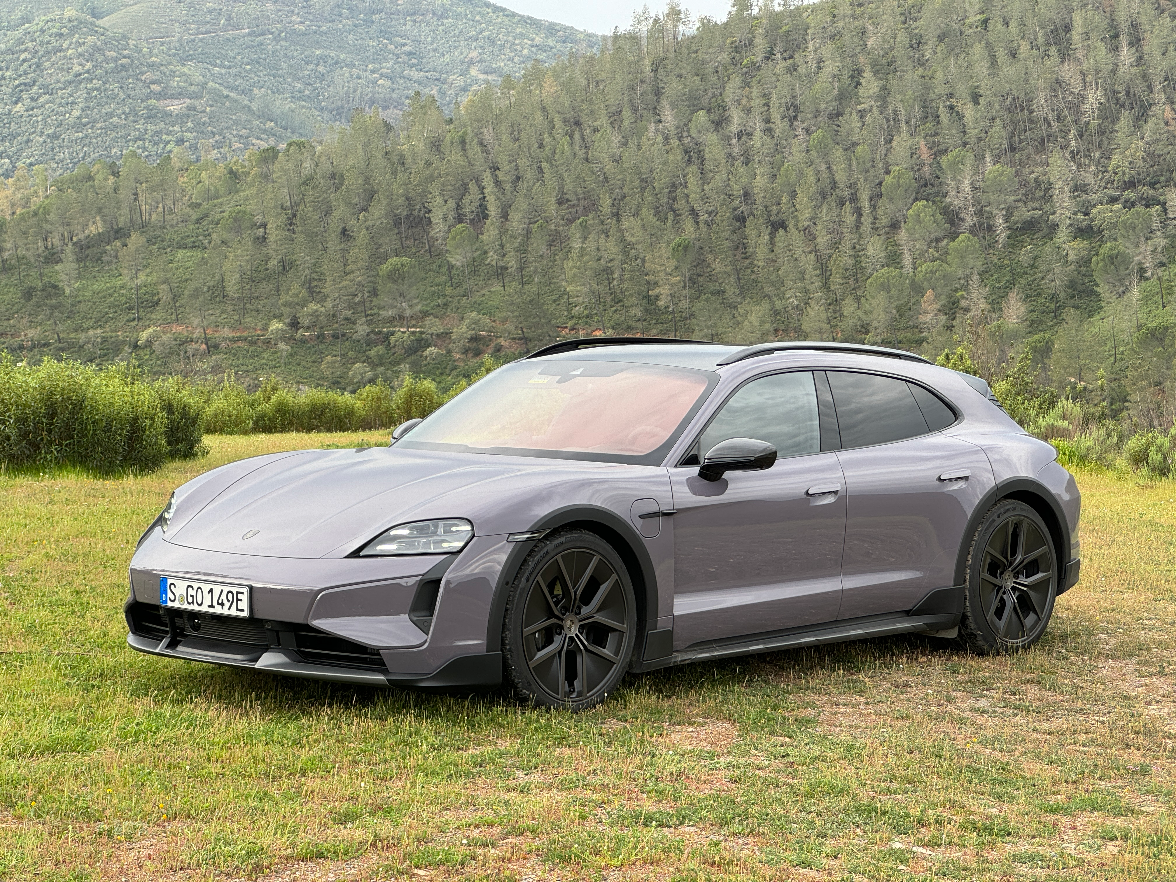 Front 3/4 view of a lavender 2025 Porsche Taycan Turbo S Cross Turismo