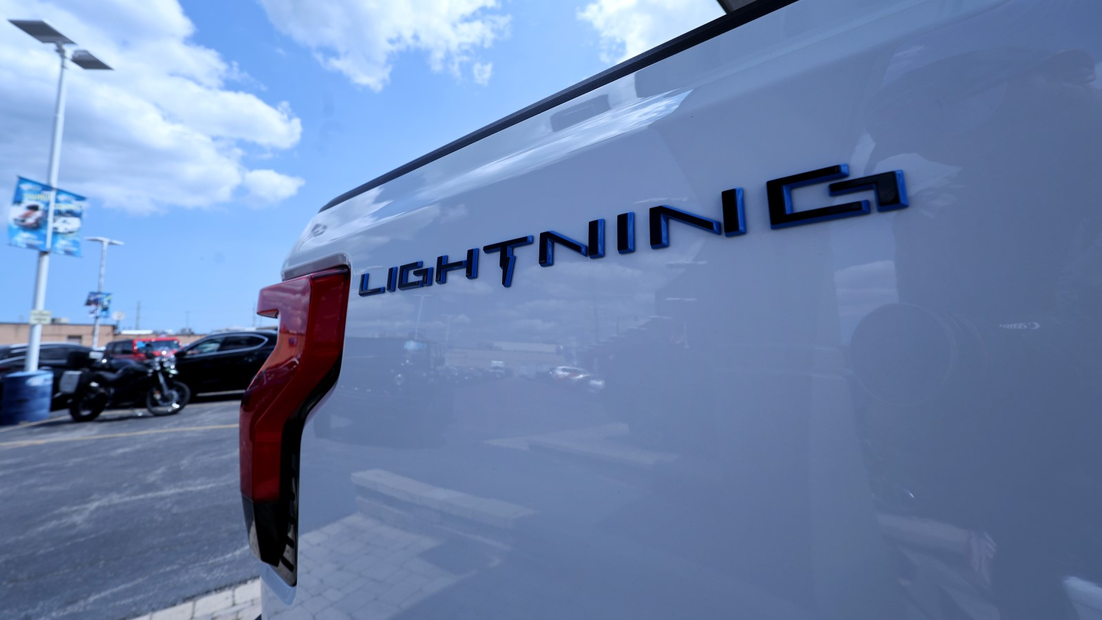 A photo of the logo on a Ford F-150 Lightning truck. 