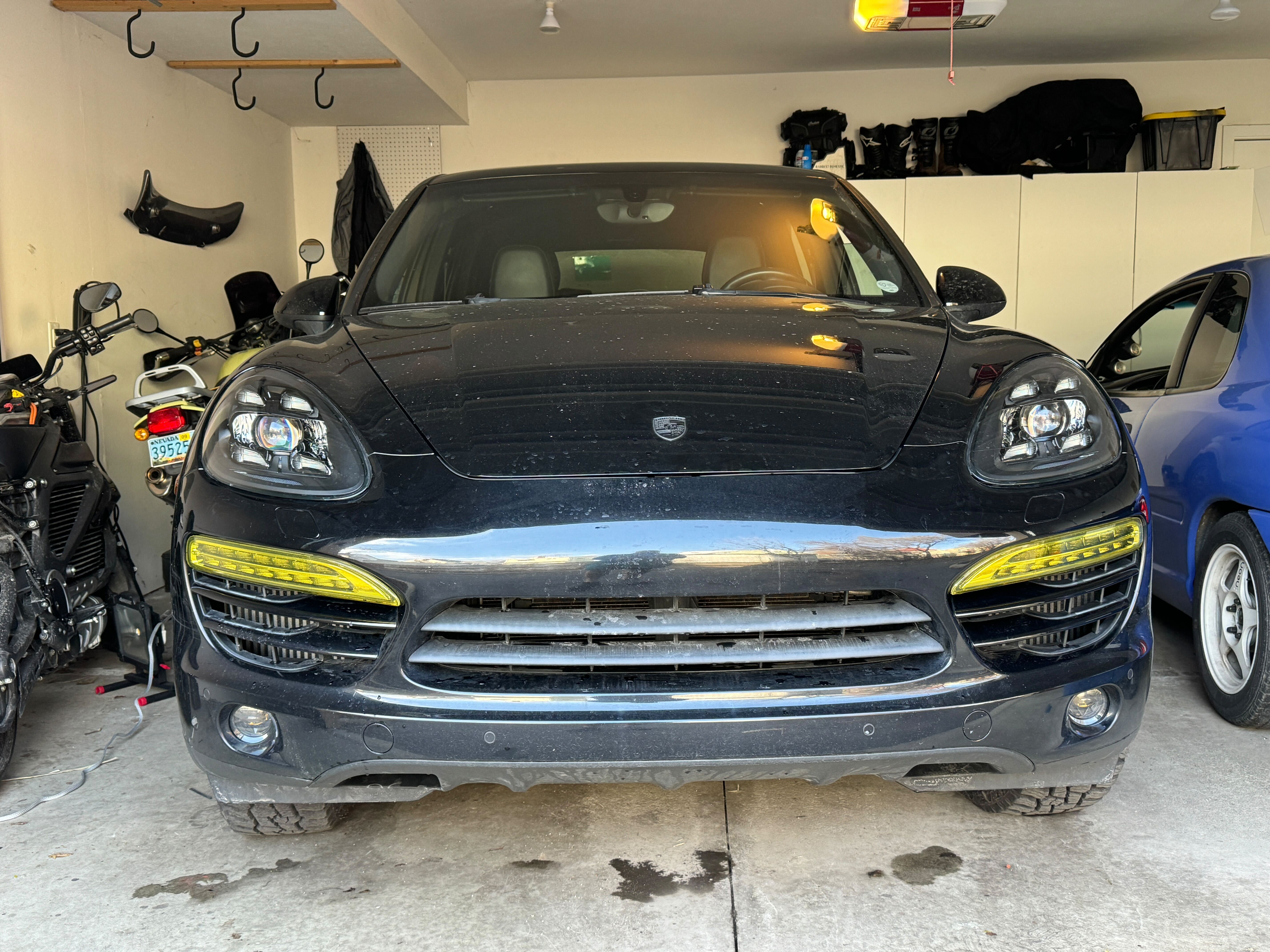 Front view of 2013 Porsche Cayenne Diesel with Lightwerks headlights and Rennline fog lights - Yellow DRL