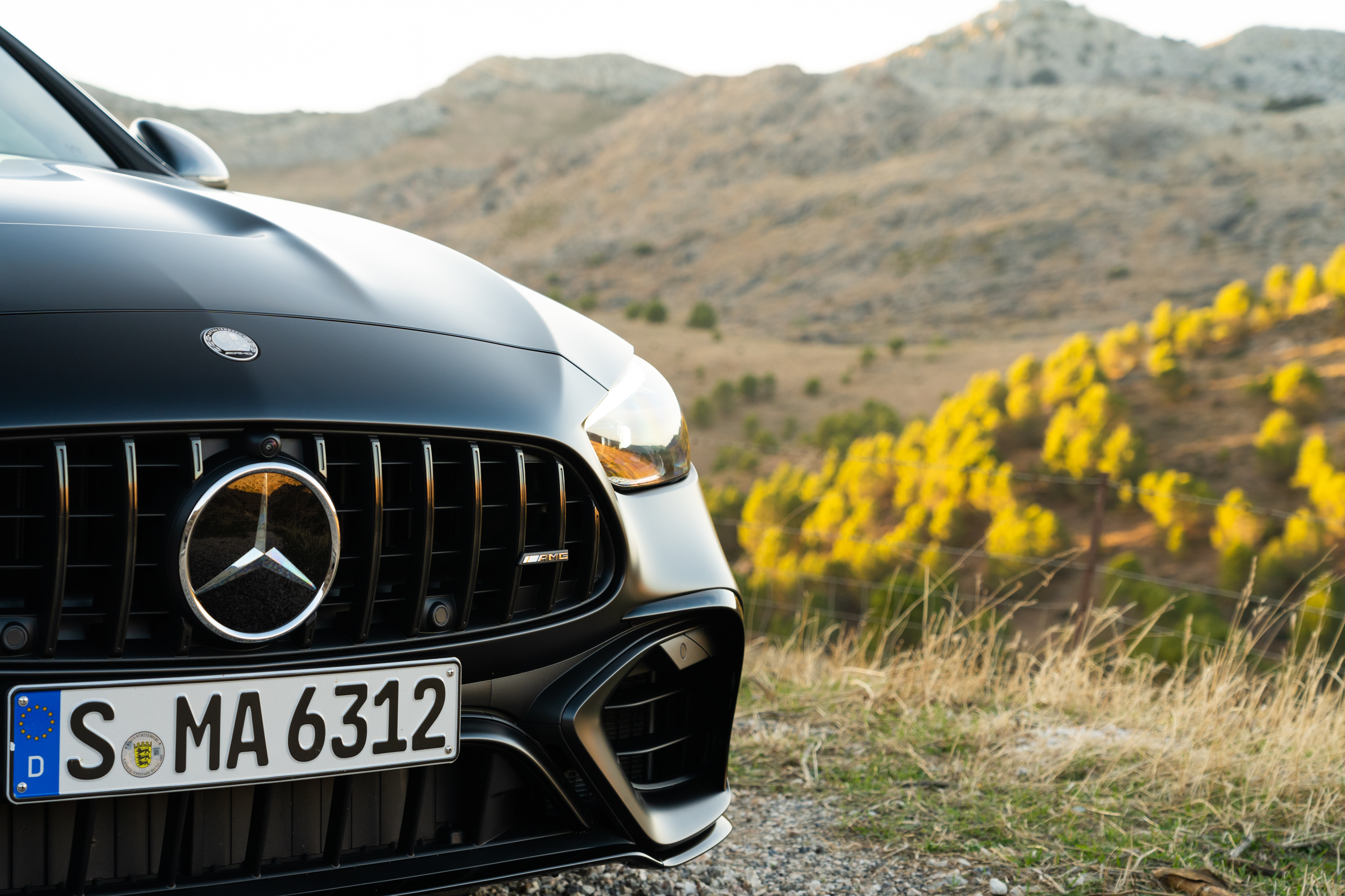 2023 mercedes-amg c 63 s e-performance in matte black photographed on the side of a mountain road in spain