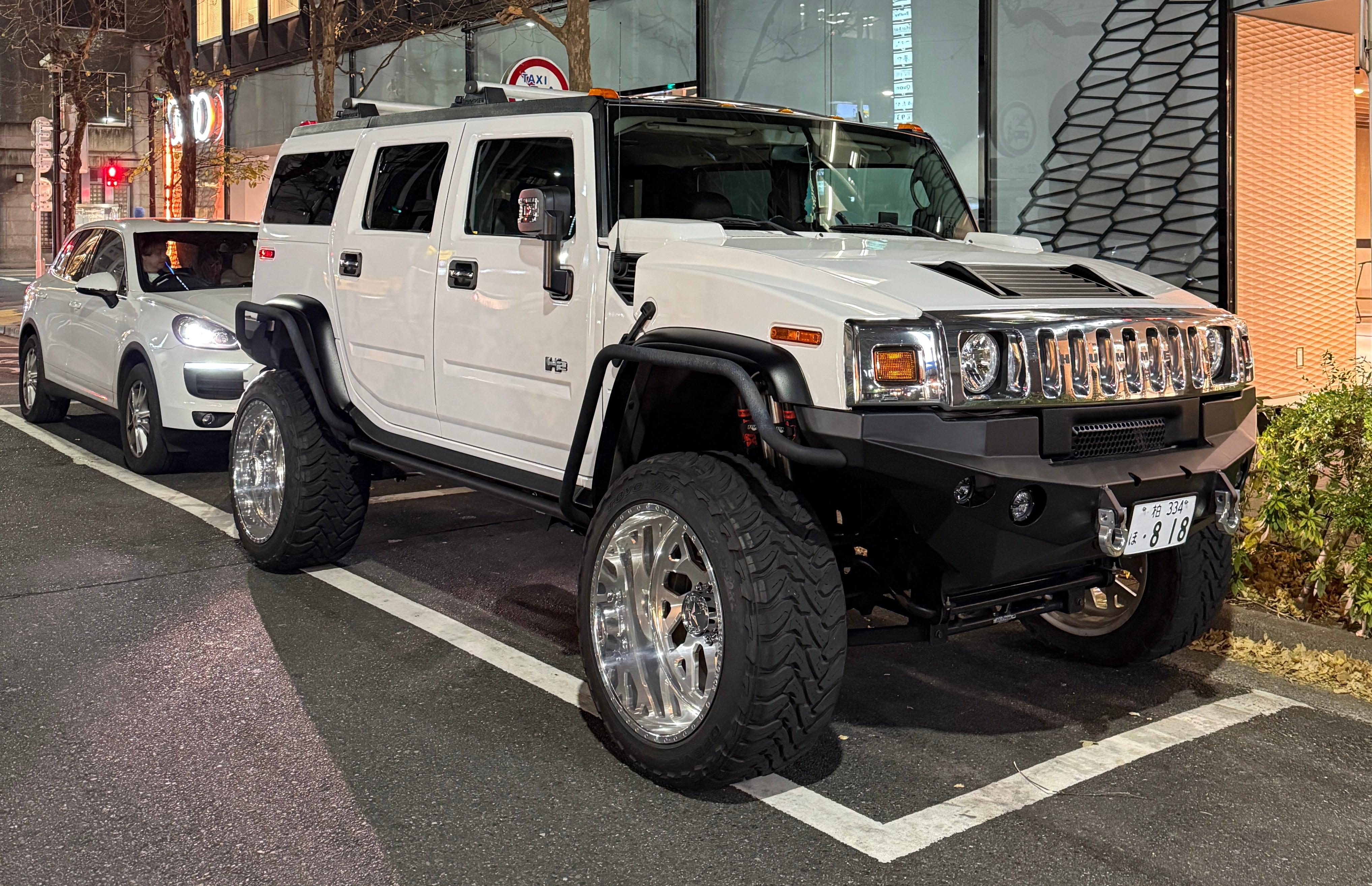 Front 3/4 view of a lifted white Hummer H2